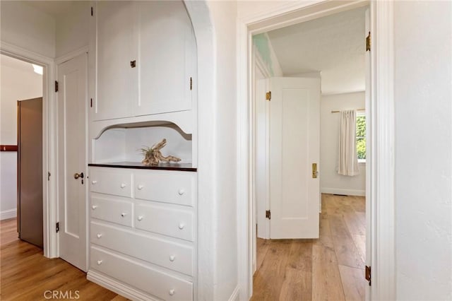 94 E Highland Ave, Sierra Madre, CA 91024 - hallway with light wood-style flooring, baseboards, and arched walkways