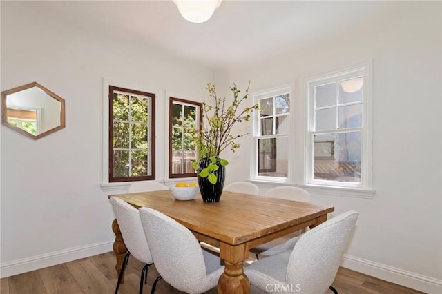 94 E Highland Ave, Sierra Madre, CA 91024 - dining area with baseboards, plenty of natural light, and wood finished floors