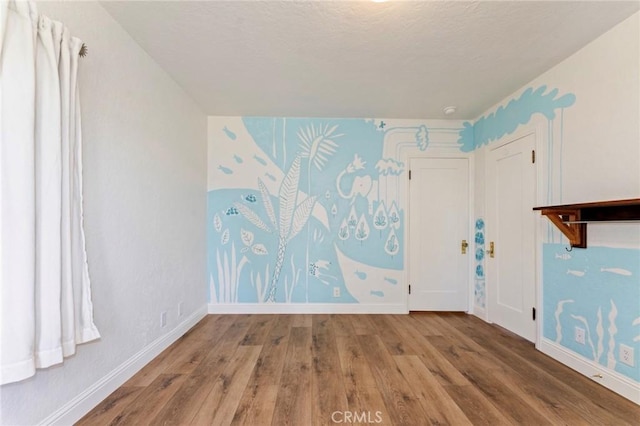 94 E Highland Ave, Sierra Madre, CA 91024 - empty room featuring wood finished floors and baseboards