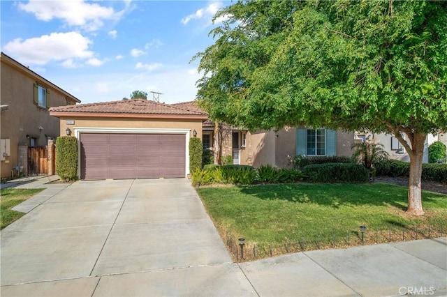 40991 Bankhall St, Lake Elsinore, CA 92532 - view of front facade featuring stucco siding, driveway, a front lawn, and a garage