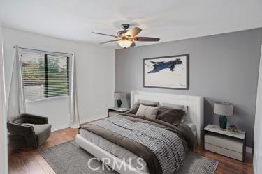 27929 Tyler Ln Unit 744, Canyon Country, CA 91387 - bedroom with wood finished floors, ceiling fan, and baseboards