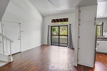 27929 Tyler Ln Unit 744, Canyon Country, CA 91387 - unfurnished room with dark wood finished floors, stairs, and vaulted ceiling