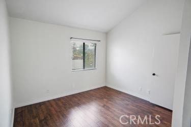 27929 Tyler Ln Unit 744, Canyon Country, CA 91387 - unfurnished room with wood finished floors, vaulted ceiling, and baseboards