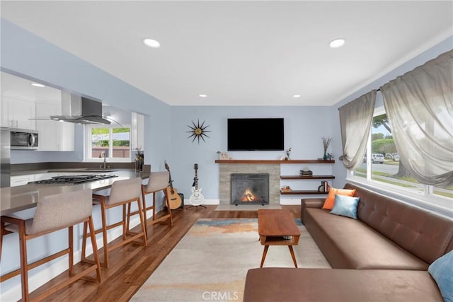 2829 Albury Ave, Long Beach, CA 90815 - living area featuring wood finished floors, a fireplace with flush hearth, recessed lighting, and baseboards