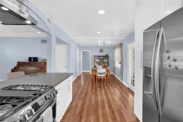 2829 Albury Ave, Long Beach, CA 90815 - kitchen featuring appliances with stainless steel finishes, white cabinetry, light wood-type flooring, wall chimney range hood, and recessed lighting