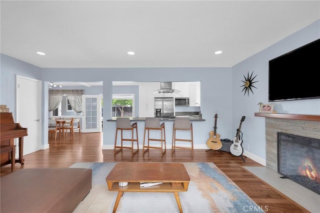2829 Albury Ave, Long Beach, CA 90815 - living area with a stone fireplace, wood finished floors, stairway, baseboards, and recessed lighting