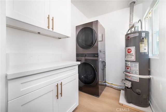 10091011 W Myrtle St, Santa Ana, CA 92703 - laundry room with gas water heater, stacked washer and clothes dryer, cabinet space, and light wood-style floors