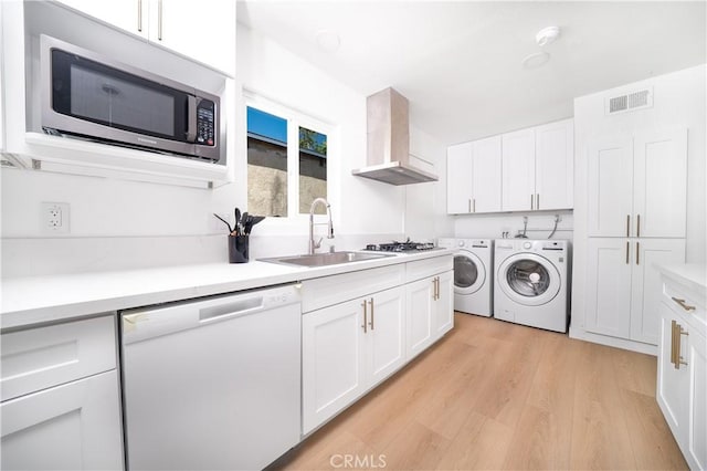10091011 W Myrtle St, Santa Ana, CA 92703 - washroom featuring washer and clothes dryer and light wood-type flooring