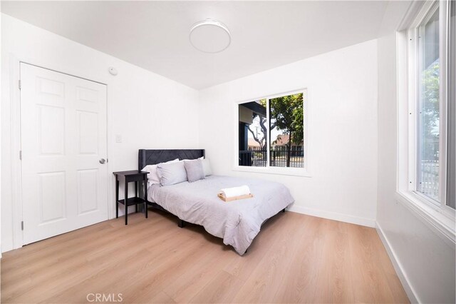 10091011 W Myrtle St, Santa Ana, CA 92703 - bedroom with light wood-type flooring and baseboards