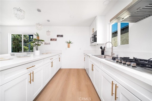 10091011 W Myrtle St, Santa Ana, CA 92703 - kitchen with wall chimney exhaust hood, a sink, white cabinets, light wood-type flooring, and light countertops