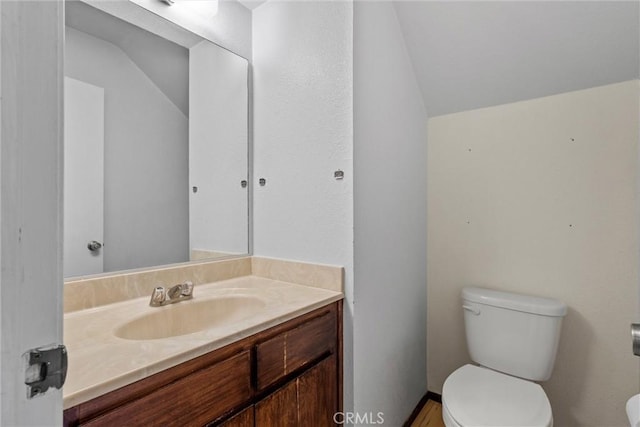 2912 Pennyroyal Dr, Chico, CA 95928 - bathroom featuring lofted ceiling, toilet, and vanity