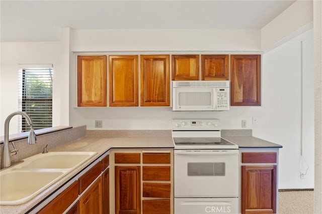 2912 Pennyroyal Dr, Chico, CA 95928 - kitchen featuring white appliances, a sink, brown cabinetry, and light countertops