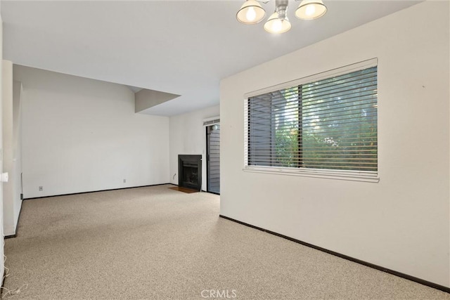 2912 Pennyroyal Dr, Chico, CA 95928 - unfurnished living room with a fireplace, baseboards, and a chandelier