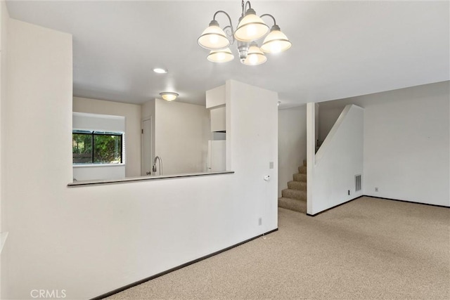 2912 Pennyroyal Dr, Chico, CA 95928 - unfurnished living room featuring stairway, carpet, a chandelier, baseboards, and a sink