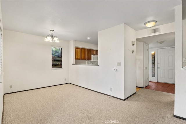 2912 Pennyroyal Dr, Chico, CA 95928 - carpeted empty room with a chandelier and baseboards