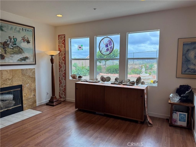 5486 Alexandrine Ct, Oceanside, CA 92057 - office space featuring healthy amount of natural light, wood finished floors, a tiled fireplace, baseboards, and recessed lighting