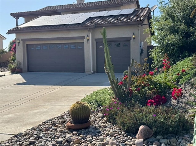 5486 Alexandrine Ct, Oceanside, CA 92057 - view of front facade with an attached garage, driveway, roof mounted solar panels, a chimney, and stucco siding