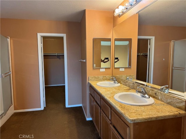 5486 Alexandrine Ct, Oceanside, CA 92057 - bathroom with baseboards, double vanity, and a spacious closet