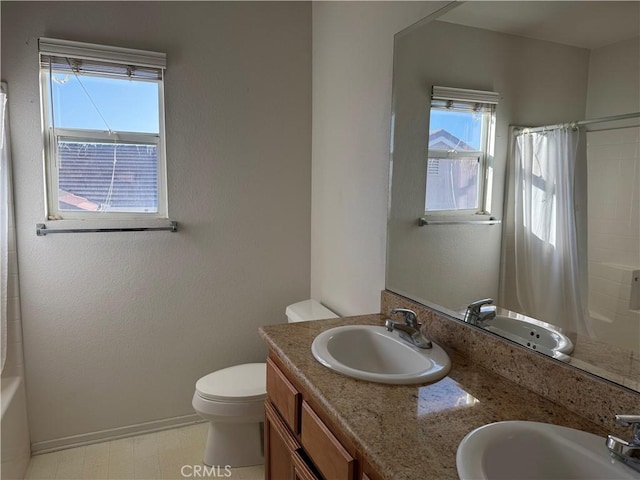 5486 Alexandrine Ct, Oceanside, CA 92057 - bathroom with double vanity, toilet, plenty of natural light, and baseboards