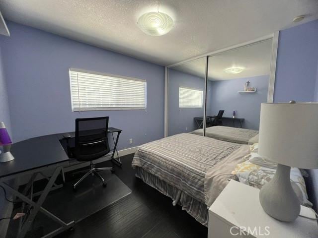 2163 N Justin Ave N, Simi Valley, CA 93065 - bedroom featuring a desk, dark wood finished floors, a closet, and a textured ceiling