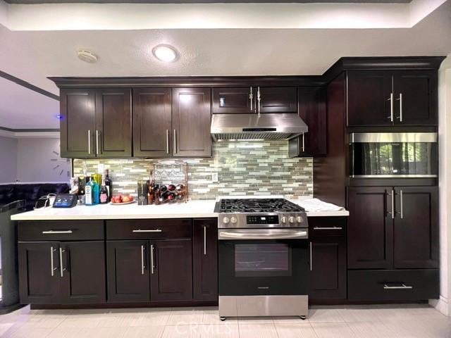 2163 N Justin Ave N, Simi Valley, CA 93065 - kitchen featuring gas range, under cabinet range hood, tasteful backsplash, and light countertops