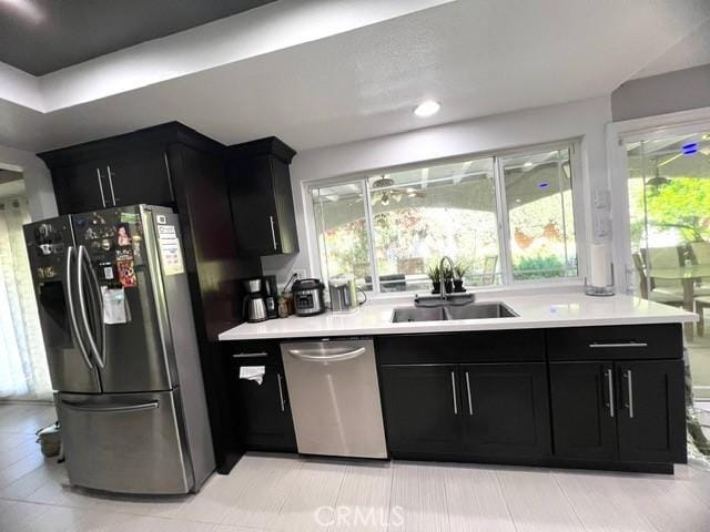 2163 N Justin Ave N, Simi Valley, CA 93065 - kitchen with appliances with stainless steel finishes, a sink, dark cabinetry, and light countertops