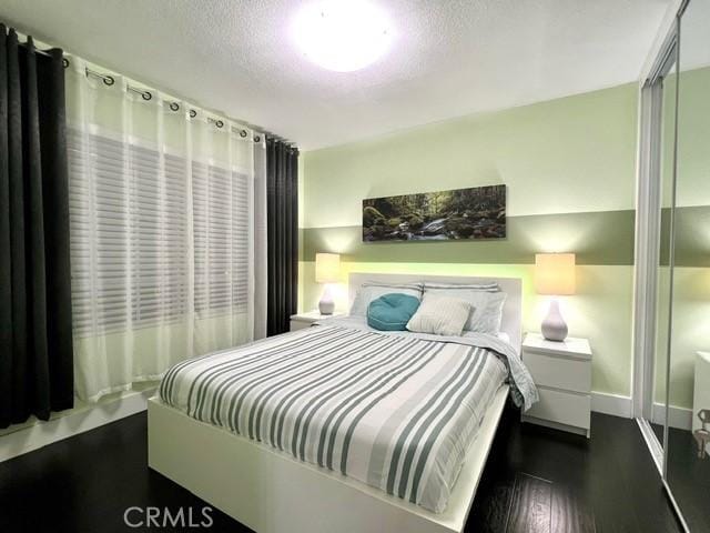 2163 N Justin Ave N, Simi Valley, CA 93065 - bedroom with a textured ceiling, dark wood-style floors, and baseboards