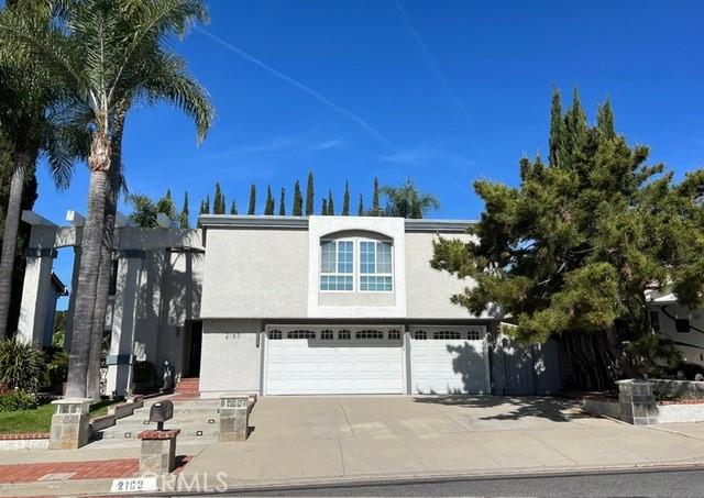 2163 N Justin Ave N, Simi Valley, CA 93065 - view of front of house featuring a garage, stucco siding, and driveway