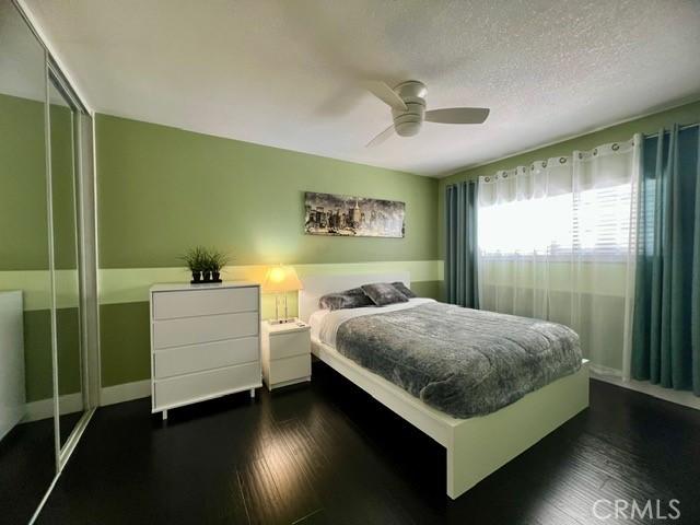 2163 N Justin Ave N, Simi Valley, CA 93065 - bedroom with a closet, dark wood-style floors, ceiling fan, baseboards, and a textured ceiling