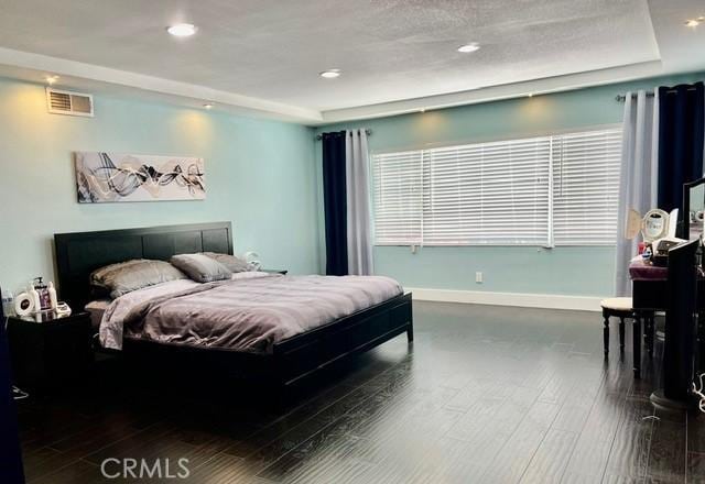 2163 N Justin Ave N, Simi Valley, CA 93065 - bedroom with wood finished floors, baseboards, a tray ceiling, and recessed lighting