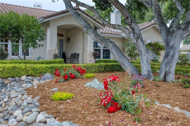 635 Shelter Ridge Pl, Nipomo, CA 93444 - doorway to property with a chimney, stucco siding, and a tiled roof