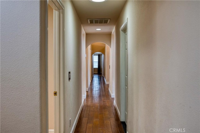 635 Shelter Ridge Pl, Nipomo, CA 93444 - corridor featuring arched walkways, dark wood-style floors, and a textured wall