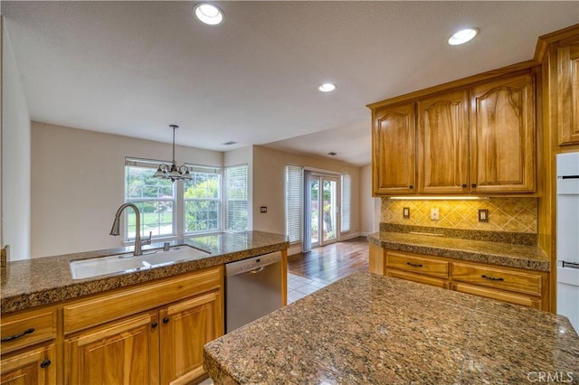 635 Shelter Ridge Pl, Nipomo, CA 93444 - kitchen featuring dishwasher, dark countertops, brown cabinetry, backsplash, and a chandelier