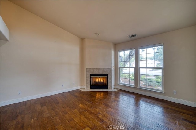 635 Shelter Ridge Pl, Nipomo, CA 93444 - unfurnished living room featuring hardwood / wood-style flooring, a tiled fireplace, and vaulted ceiling