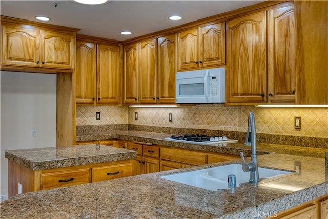 635 Shelter Ridge Pl, Nipomo, CA 93444 - kitchen with white microwave, brown cabinetry, gas stovetop, tile countertops, and recessed lighting