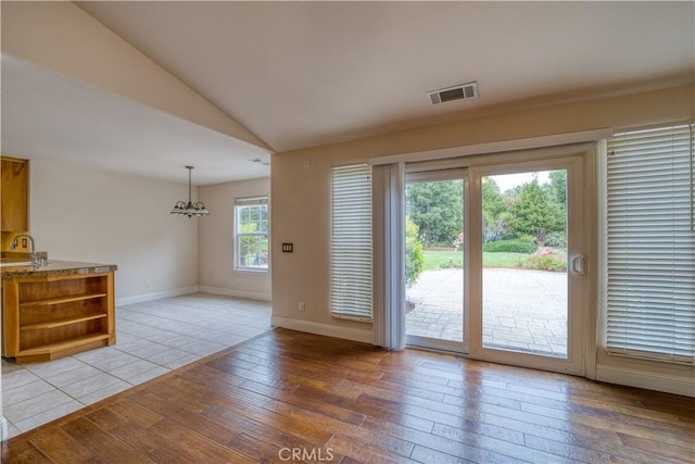 635 Shelter Ridge Pl, Nipomo, CA 93444 - doorway to outside with light wood finished floors, vaulted ceiling, and a chandelier
