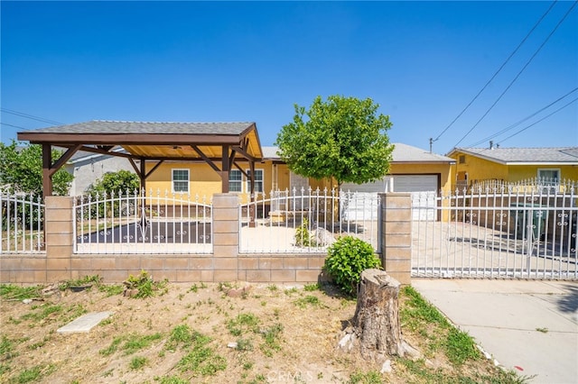 1963 Turrill Ave, San Bernardino, CA 92411 - bungalow-style house featuring a fenced front yard, stucco siding, an attached garage, and driveway