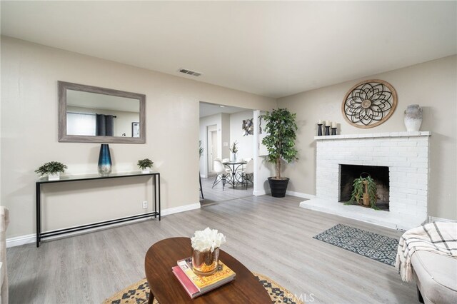 1963 Turrill Ave, San Bernardino, CA 92411 - living room with wood finished floors, baseboards, and a fireplace