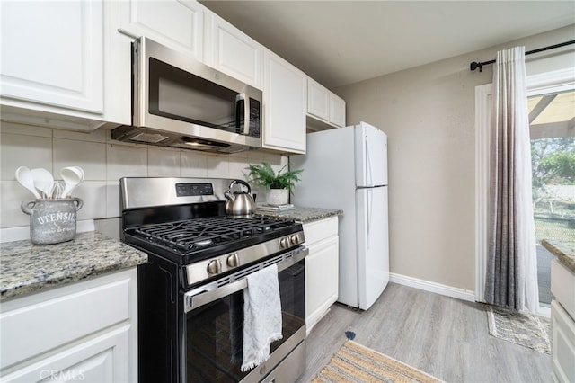 1963 Turrill Ave, San Bernardino, CA 92411 - kitchen featuring appliances with stainless steel finishes, backsplash, white cabinets, and light wood-type flooring
