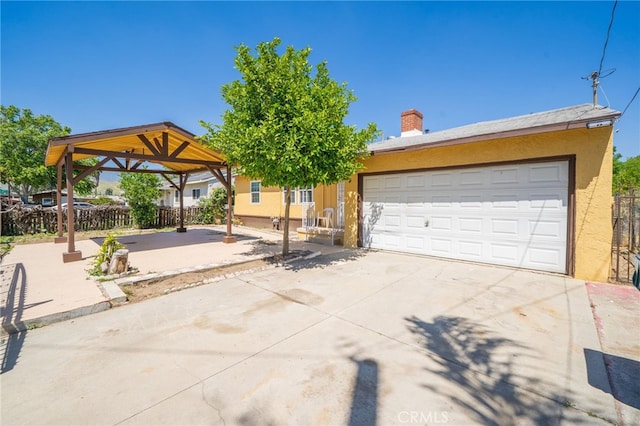 1963 Turrill Ave, San Bernardino, CA 92411 - view of front of property with stucco siding, a chimney, concrete driveway, and a gazebo