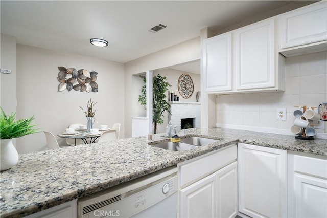 1963 Turrill Ave, San Bernardino, CA 92411 - kitchen with dishwasher, backsplash, a sink, white cabinets, and a fireplace