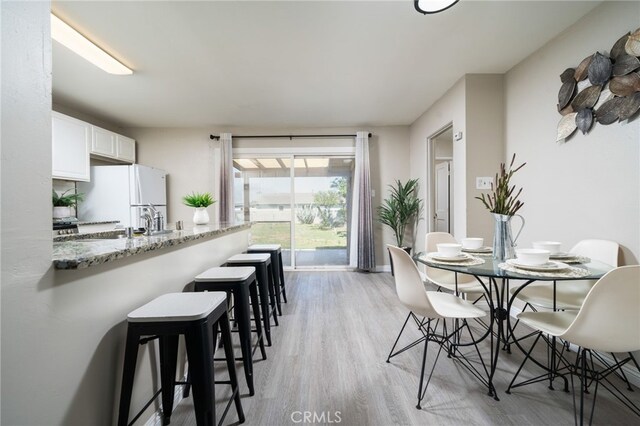 1963 Turrill Ave, San Bernardino, CA 92411 - dining space featuring light wood-style flooring and baseboards