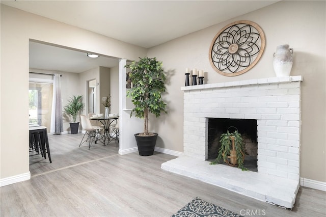 1963 Turrill Ave, San Bernardino, CA 92411 - living room featuring wood finished floors, baseboards, and a brick fireplace