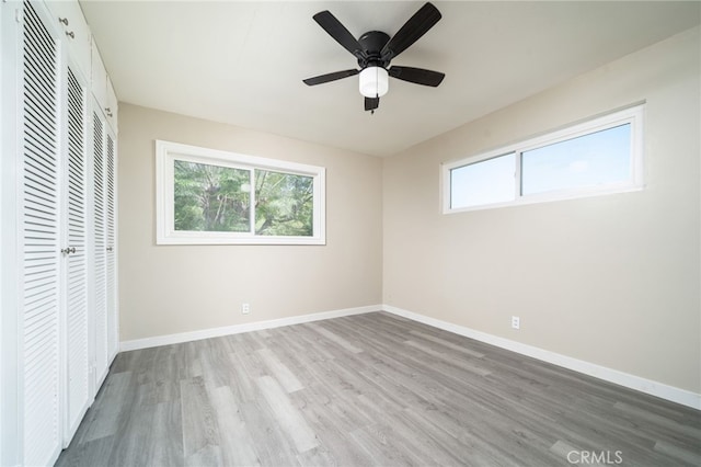 1963 Turrill Ave, San Bernardino, CA 92411 - unfurnished bedroom with multiple windows, wood finished floors, a closet, and baseboards