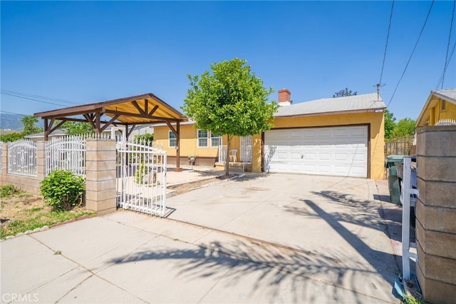 1963 Turrill Ave, San Bernardino, CA 92411 - view of front facade featuring a garage, fence, stucco siding, and a gate