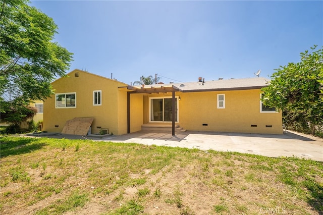 1963 Turrill Ave, San Bernardino, CA 92411 - back of property with stucco siding and a patio