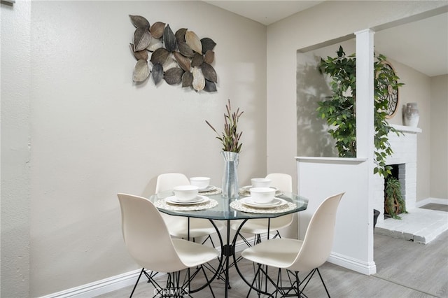 1963 Turrill Ave, San Bernardino, CA 92411 - dining area featuring wood finished floors, baseboards, and a fireplace