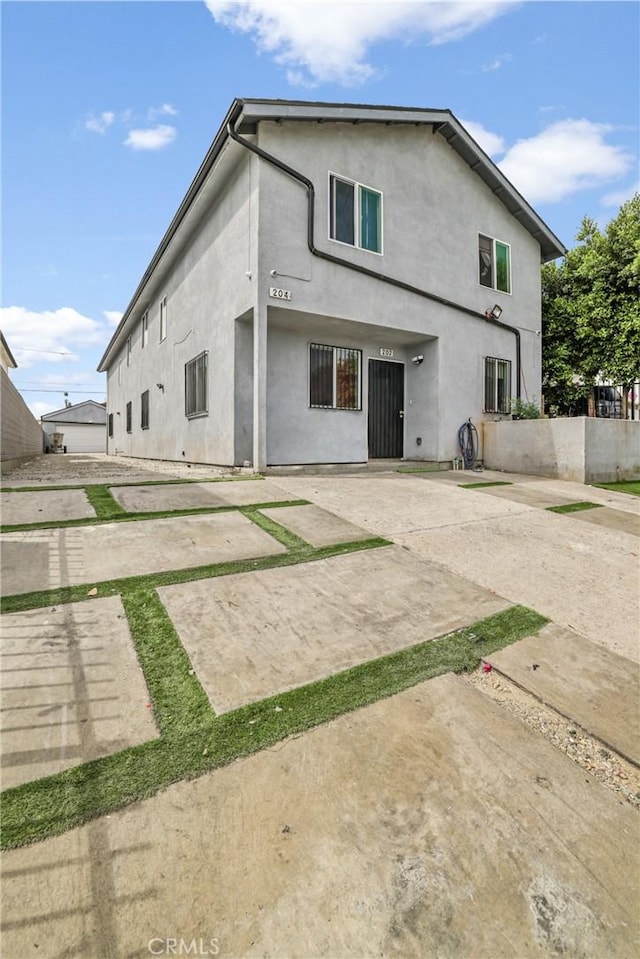 202 E 116th St, Los Angeles, CA 90061 - rear view of property with a patio and stucco siding