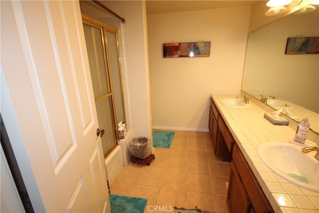 4041 Bluff Pl Unit 2, San Pedro, CA 90731 - full bathroom featuring double vanity, tile patterned floors, shower / bath combination with glass door, and baseboards