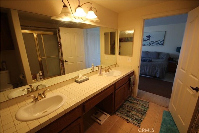 4041 Bluff Pl Unit 2, San Pedro, CA 90731 - bathroom featuring a shower stall, double vanity, tile patterned flooring, and a chandelier